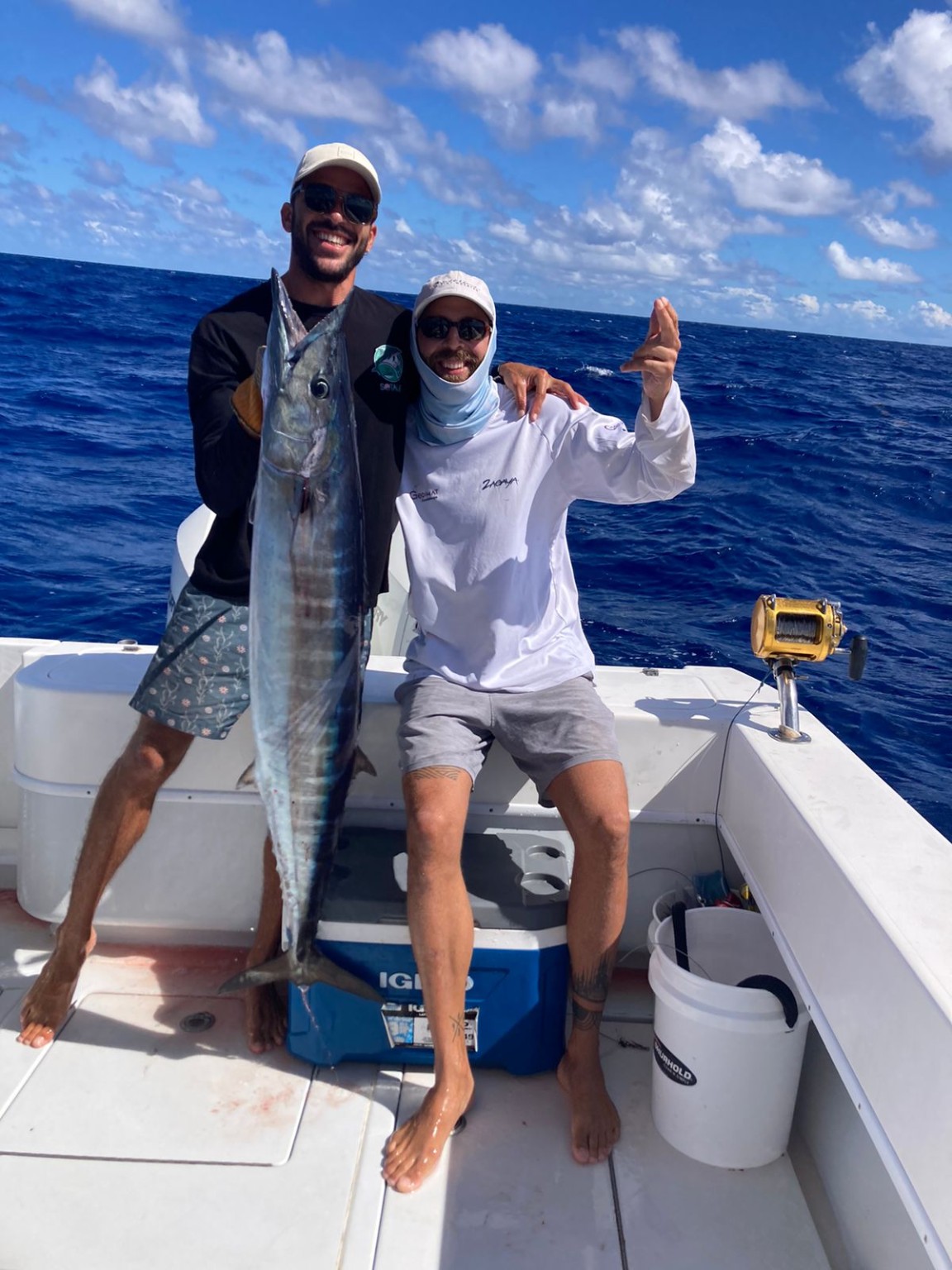 Guests with a wahoo after an offshore fishing trip